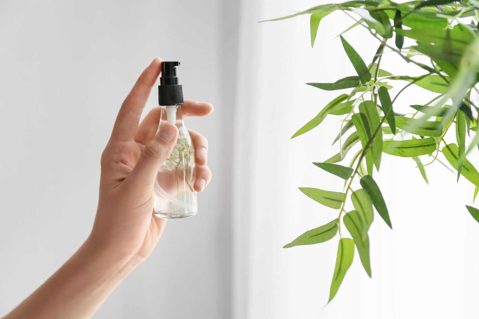 Woman using natural air freshener at home