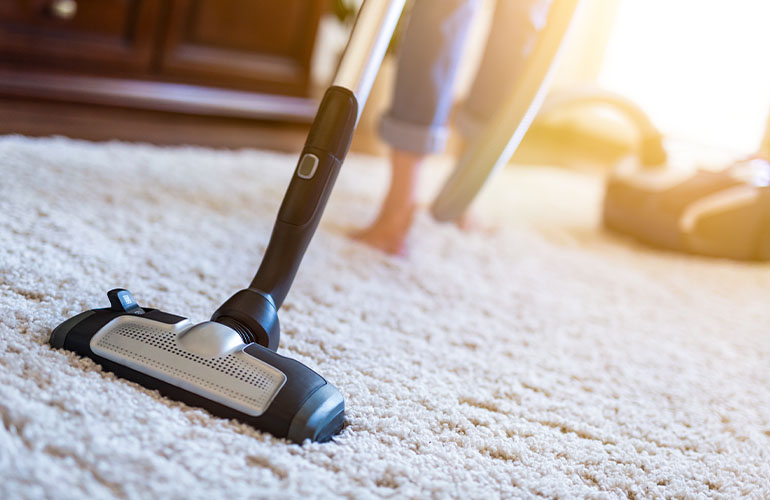 Hoover across cream carpet