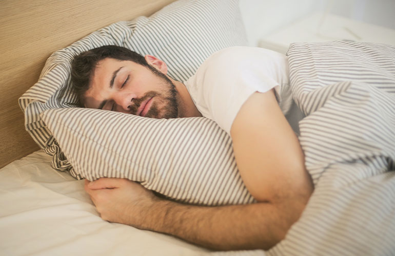 man sleeping in bed